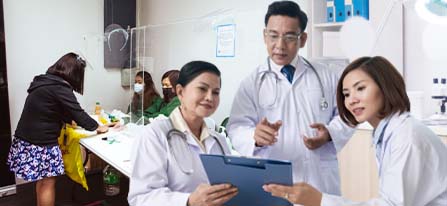 A photo of doctors with a patient registering at the background.