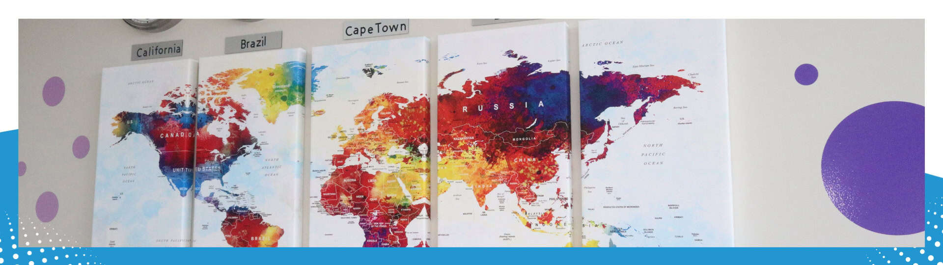 A vibrant multi-panel world map showcasing colorful continents, labeled with regions such as California, Brazil, and Cape Town, displayed on a wall with decorative elements.