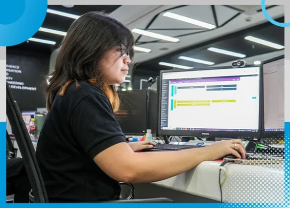 A Shore360 team member focused on her computer screen while working in a modern, well-lit office environment with sleek, professional decor.