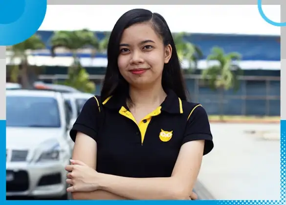 Confident team member standing outdoors in a black polo shirt, showcasing professionalism and dedication."