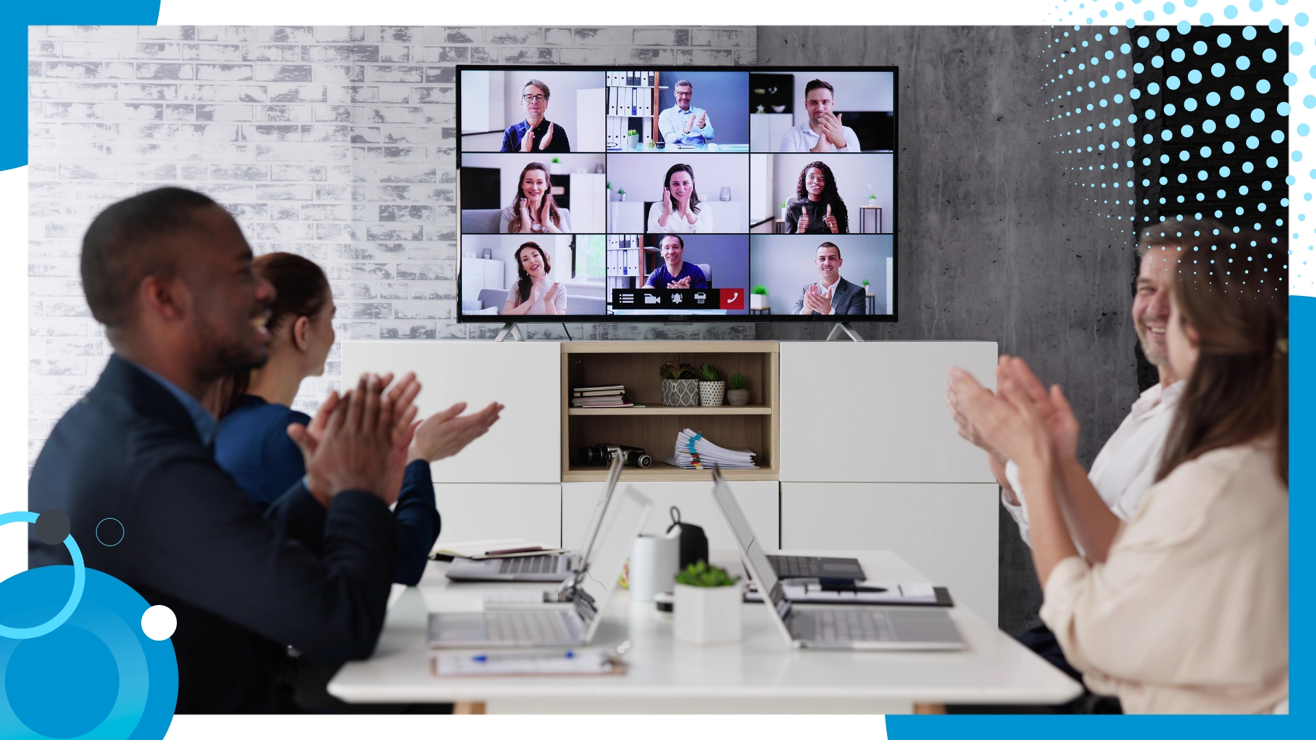 Hybrid team applauding during a virtual team-building session with remote colleagues on a video call.