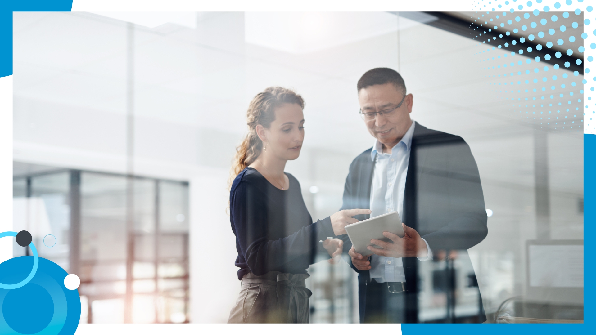 Business professionals discussing insights on a digital tablet in a modern office environmen