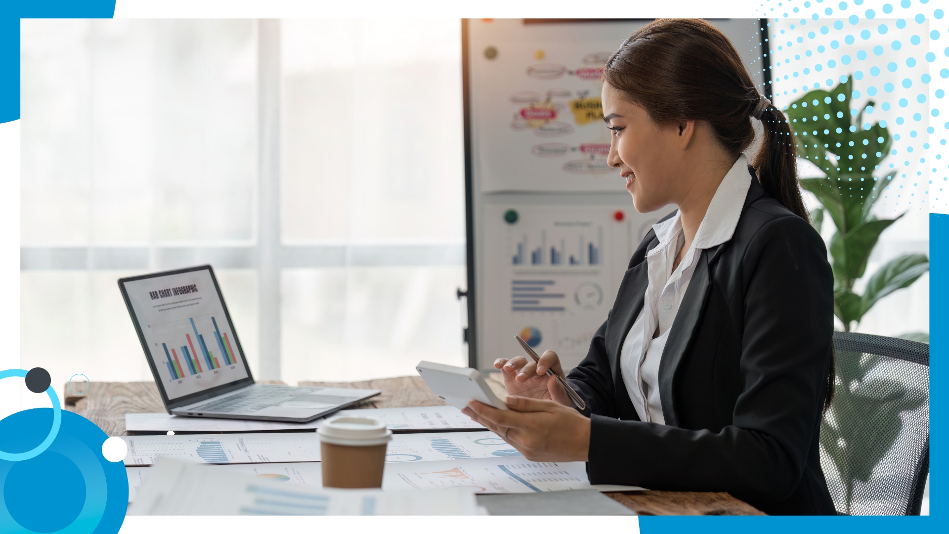Businesswoman analyzing bar charts and financial data on a laptop and tablet at a desk