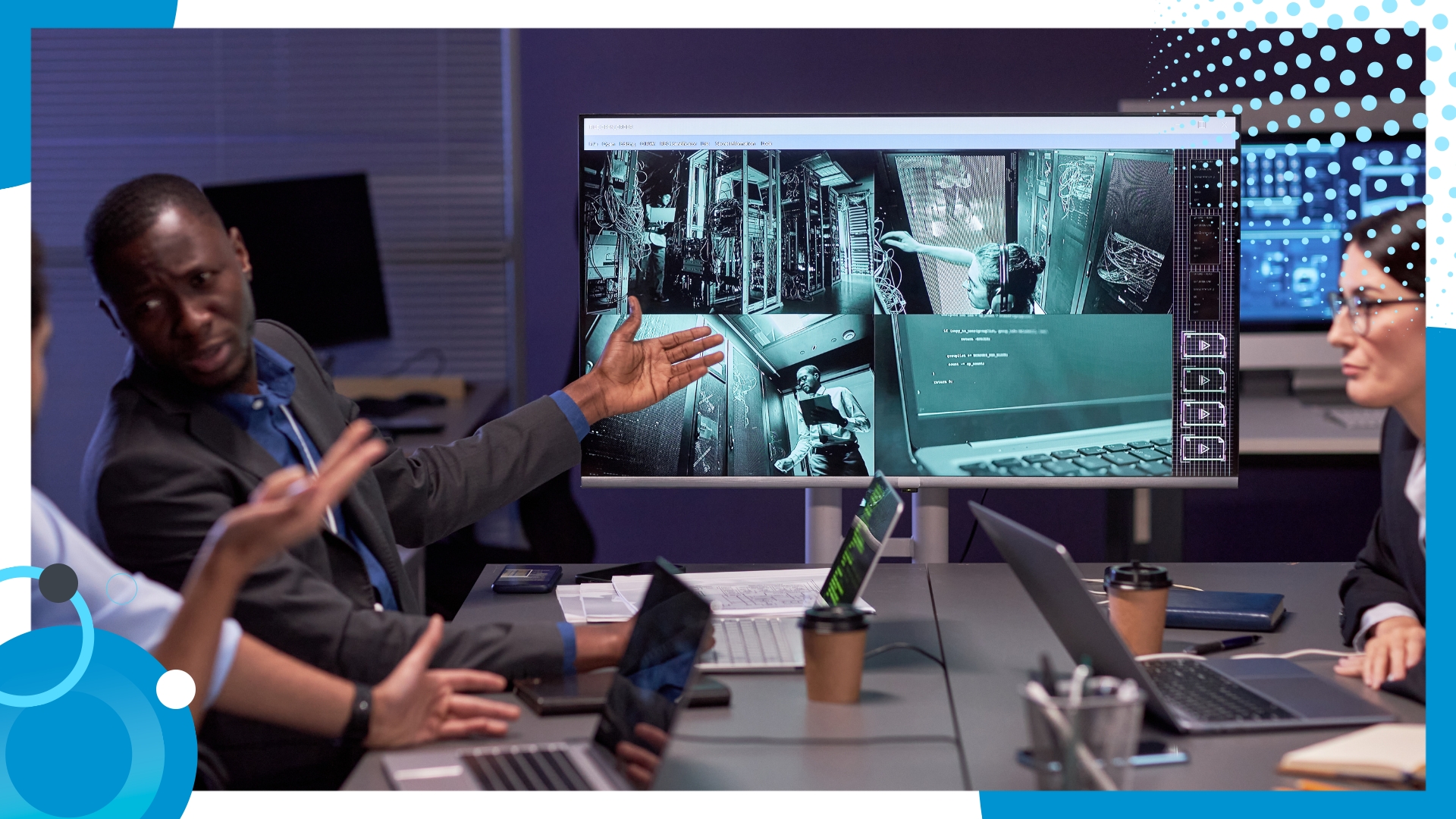 Team of cybersecurity professionals reviewing surveillance footage and data on a large monitor in a dark office