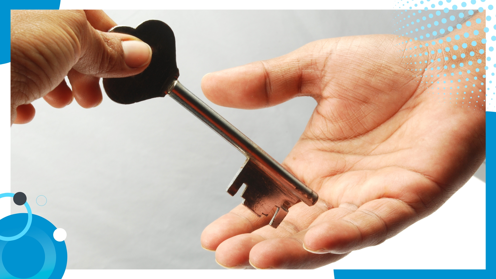 Close-up of one person handing over a vintage key to another, symbolizing trust and responsibility