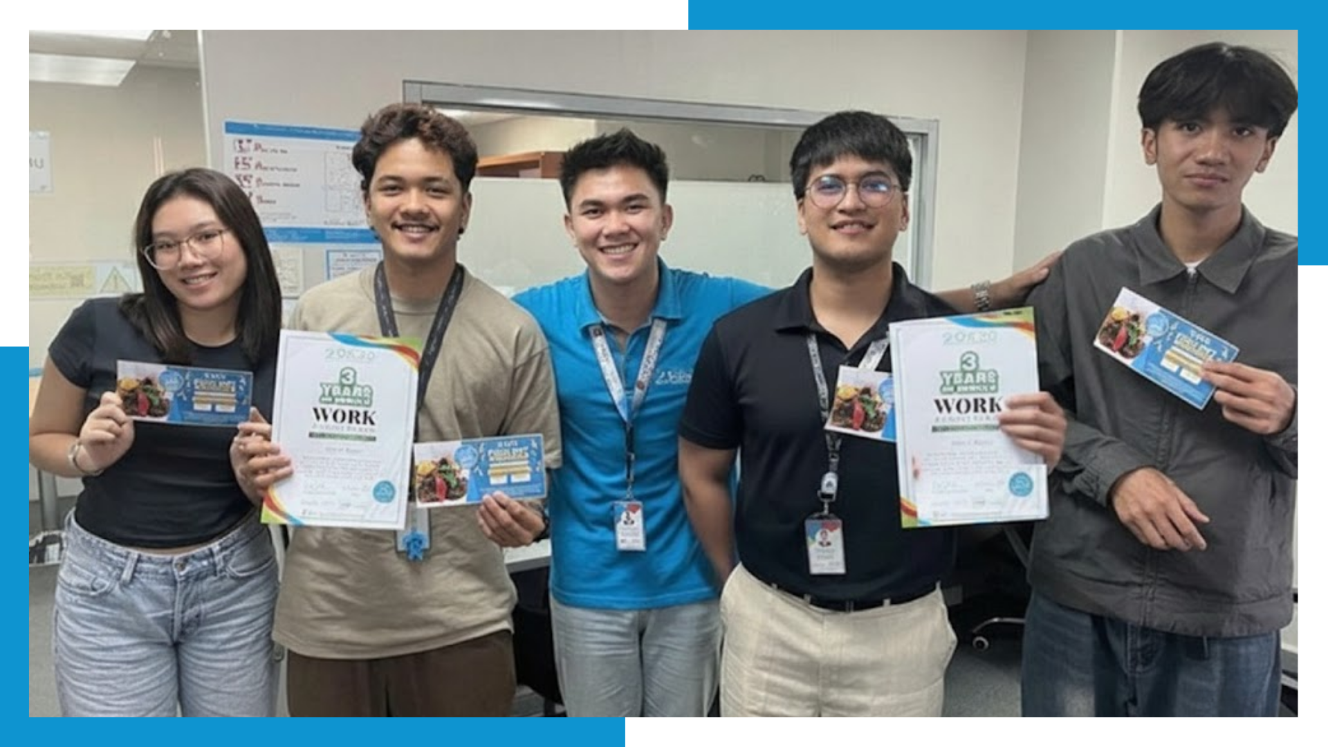 Shore360 employees receiving work anniversary certificates and gift vouchers