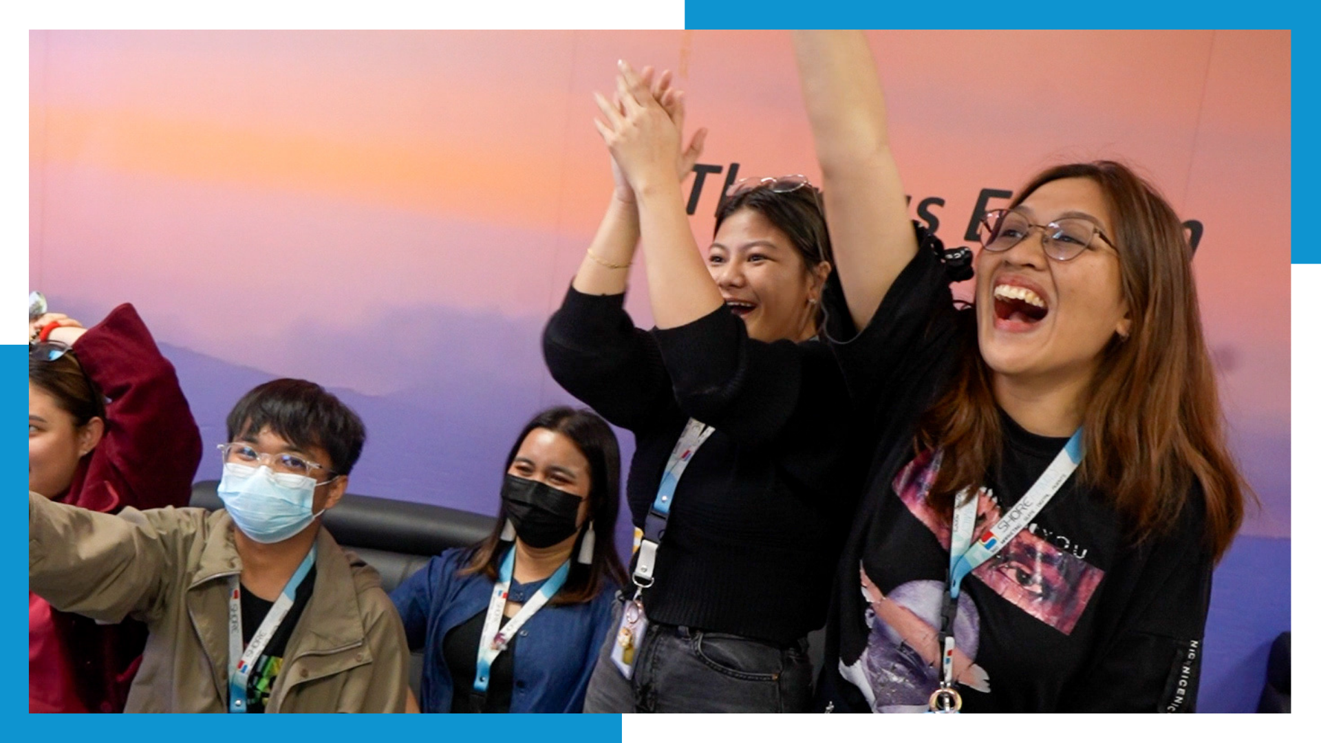 Shore360 employees cheering and celebrating during a recognition event