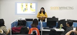 A ShoreMarketing employee (the Marketing department of Shore360, Inc.) discussing with her teammates.